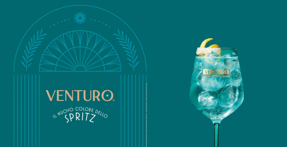 Venturo Spritz showing a blue cocktail in a wine glass with ice and a lemon peel, set against a teal background.